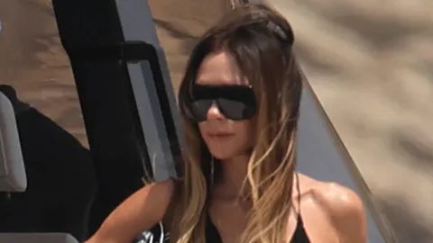 Victoria Beckham wears plunging sundress as she joins her family on board luxury yacht in Ibiza - after watching the World Cup in America