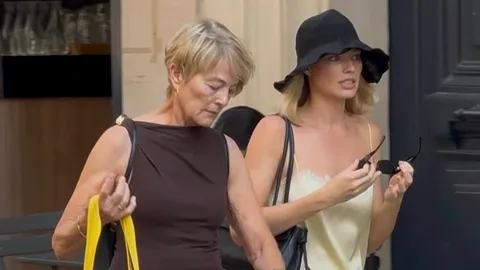Margot Robbie looks chic in a yellow silk co-ord as she joins her mother Sarie Kessler on a girls' trip to Paris