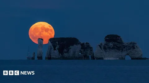 In pictures: Stunning Strawberry Moon lights up the sky