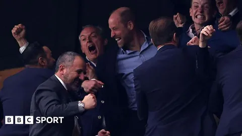 Prince William shares beer with Villa players after win