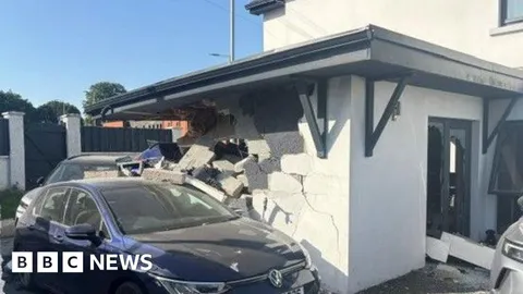 Two people arrested after car crashes into property