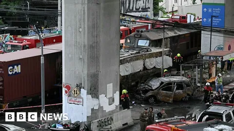Freight train and bus crash kills at least eight in Bangkok