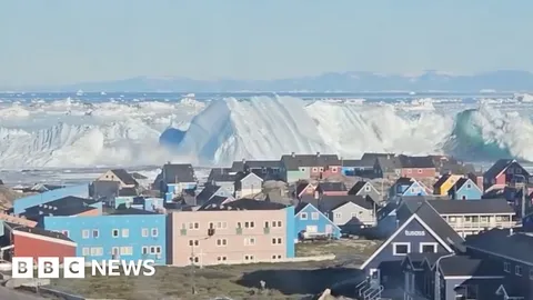Watch: Giant iceberg turns over near Greenland's coast
