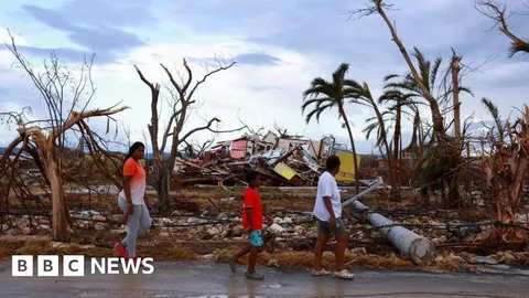 How do hurricanes and typhoons form and is climate change making them stronger?