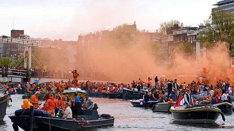 Thousands filled Amsterdam’s streets and canals to celebrate the king’s birthday