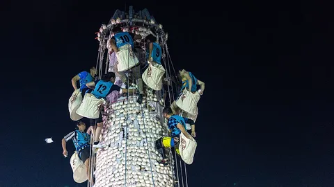 Climbers race up giant bun tower at Hong Kong’s colourful Bun Festival