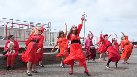 Hundreds dressed in red recreate Kate Bush’s Wuthering Heights dance