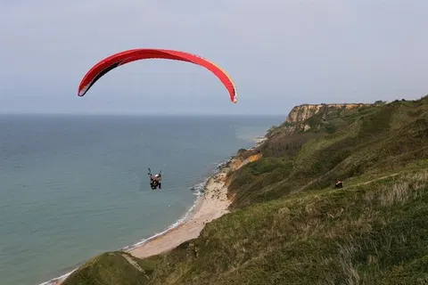 Insane Video: Sightseeing Plane Cuts Woman's Paragliding Lines Mid-Air, but She Lives to Tell the Tale