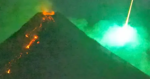 Spectacular Moment Meteor Explodes Behind Erupting Volcano Caught on Camera
