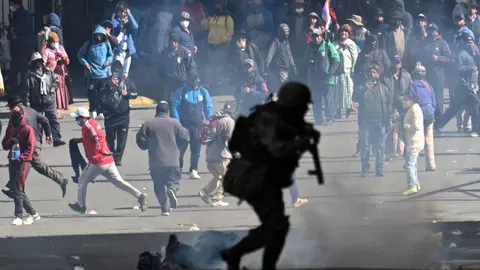 Bolivian president slashes salary by 50% to calm protests