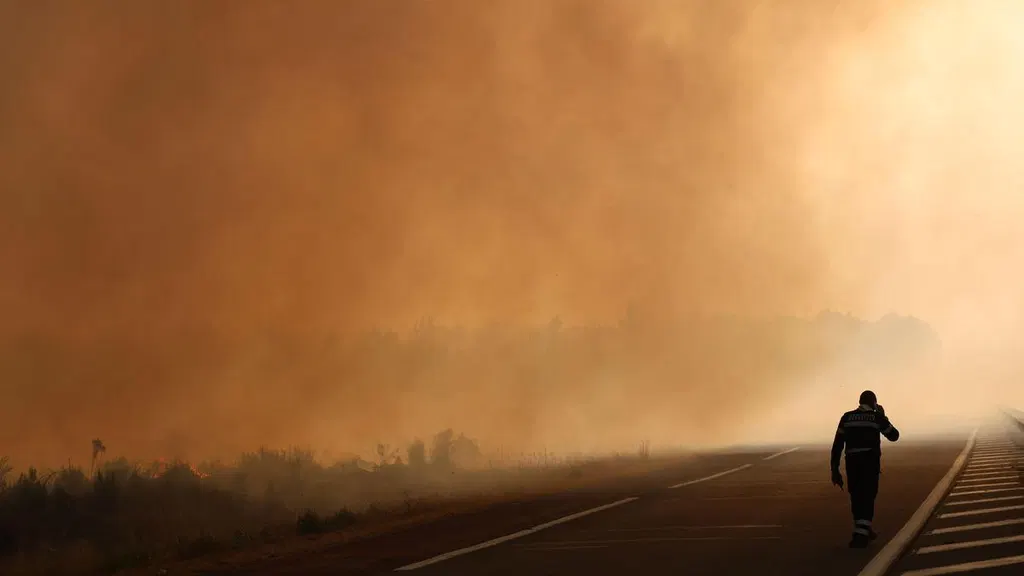 Firefighters battle to keep blazes away from France's Bordeaux; Macron calls crisis meeting