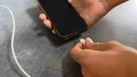 Why do phones still use battery when powered off?
